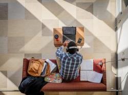 A student sitting in CELS studying on their laptop.