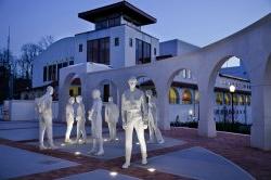 Statues outside college hall and kasser theater at night