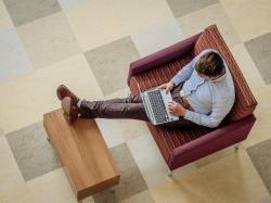 Overhead picture of a student on a laptop.