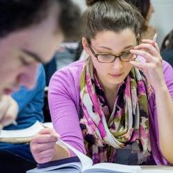 Close up of a student reading in a poetry class.