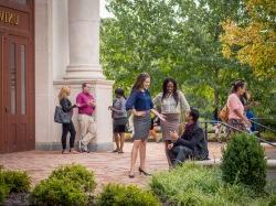 Graduate School students talking outside of 大学 Hall entrance