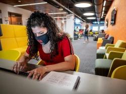 Student with mask in The Graduate School building at Montclair State