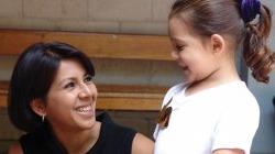 Child advocacy student laughing with young child