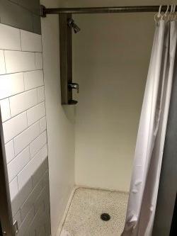 The shower stall in a bathroom in Stone Hall.