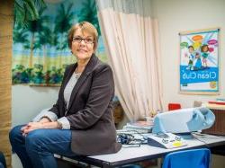 photo of Colette Crescas sitting on a desk