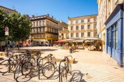 Photo of view on the small square with bicycles in Bordeaux city in France