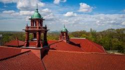 View of the top of a Montclair State University building with tree tops in background