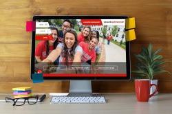 Photo of desk with computer monitor displaying Montclair State University website.